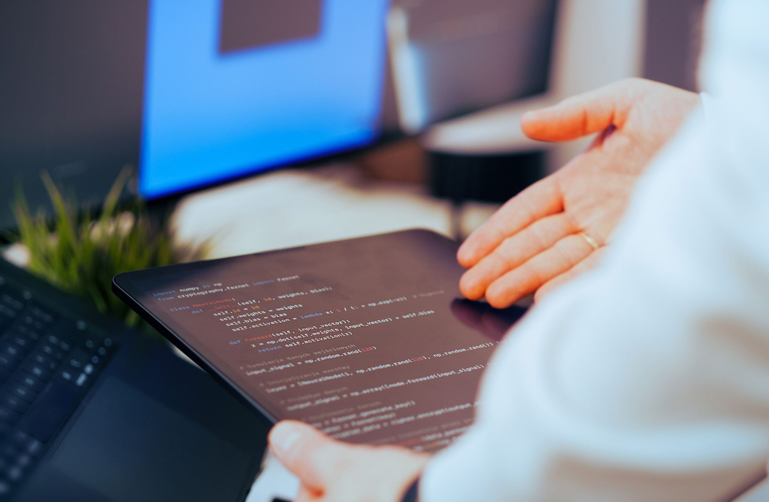 Software developer reviewing code on a tablet